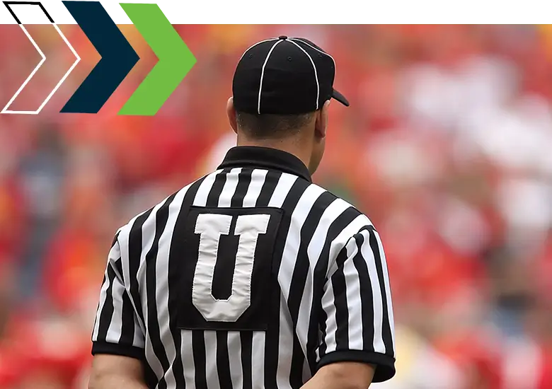 A referee is standing in front of the crowd.