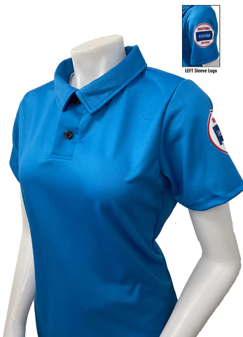 A woman wearing a blue shirt with a patch on the chest.