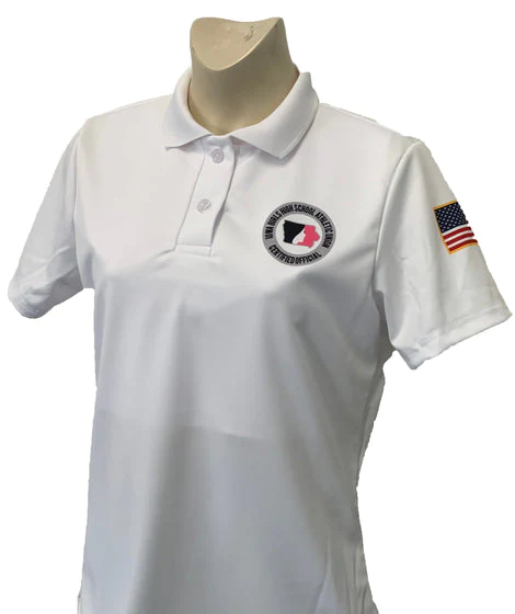 A woman wearing a white polo shirt with an american flag on the chest.