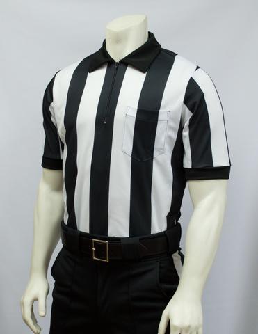 A referee shirt and pants worn by a man.