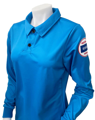 A woman wearing a blue shirt with an oil patch on the sleeve.